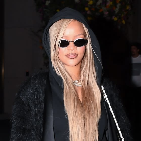  Rihanna wearing an all-black outfit and a white Chanel purse while in New York City May 2024. 