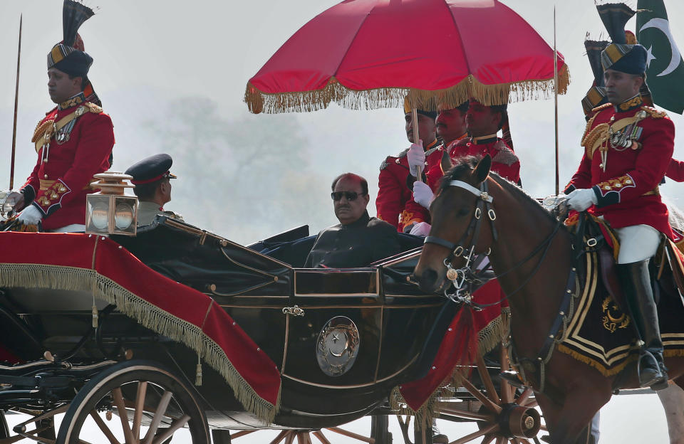 Pakistan President Mamnoon Hussain arrives to attend a military parade to mark Pakistan's Republic Day in Islamabad, Pakistan, Thursday, March 23, 2017. Hussain says Pakistan is ready to hold talks with India on all issues, including Kashmir, as he opened an annual military parade. During the parade, attended by several thousand people, Pakistan displayed nuclear-capable weapons, tanks, jets, drones and other weapons systems. (AP Photo/Anjum Naveed)