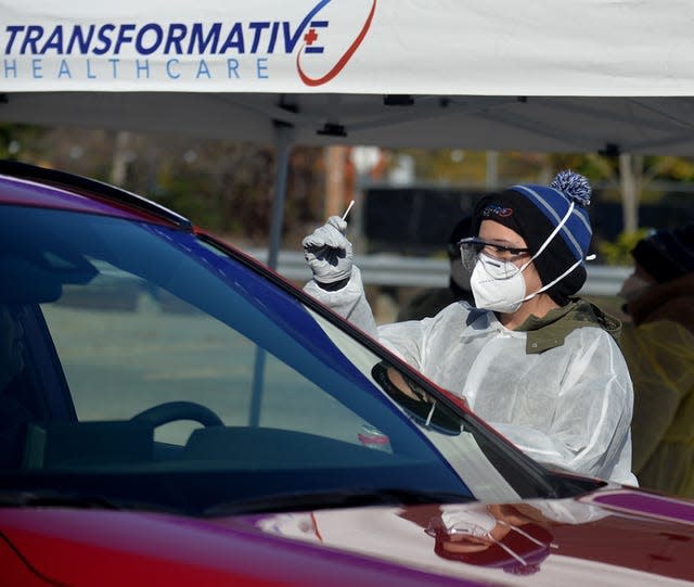 COVID-19 tests are being administered at the commuter rail parking lot in Ashland.