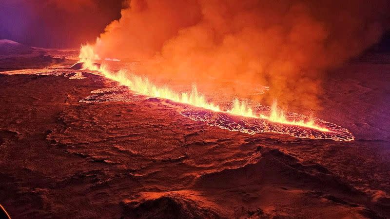 FILE PHOTO: A volcano spews lava and smoke as it erupts in Grindavik