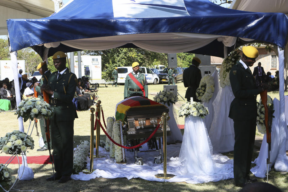 The coffin carrying the body of former Zimbabwean President Robert Mugabe is seen during mass at his rural home in Zvimba, about 100 kilometers north west of the capital Harare, Saturday. Sept, 28, 2019. According to a family spokesperson Mugabe is expected to be buried at the residence after weeks of drama mystery and contention over his burial place. (AP Photo/Tsvangirayi Mukwazhi)