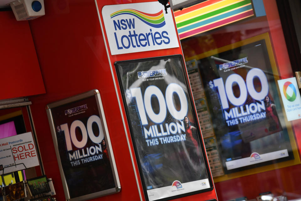 Signs advertising the NSW Lotteries $100 million Powerball outside a newsagency in Sydney, Friday, January 11, 2019. (AAP Image/Mick Tsikas)