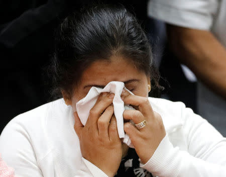 Lorenza Delos Santos, 43, mother of 17-year-old high school student Kian delos Santos who was killed in a recent war on drugs police raid, wipes her tears during a hearing at the Senate headquarters in Pasay city, metro Manila, Philippines August 24, 2017. REUTERS/Dondi Tawatao