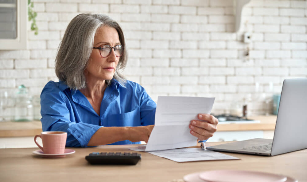 older woman reading a bill