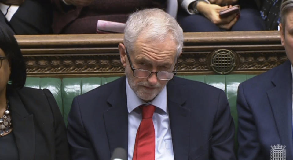 Labour leader Jeremy Corbyn listens as Prime Minister Theresa May makes a statement to MPs in the House of Commons, London, Monday, Jan. 21, 2019. British Prime Minister Theresa May has rejected calls to delay Britain's departure from the European Union, and says she will press on with efforts to get an EU divorce bill approved by Parliament. May says she will hold more talks with government and opposition lawmakers about their concerns over the deal, before going back to EU leaders. (House of Commons via AP)