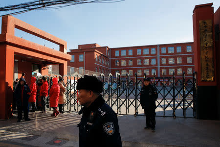 Police stand outside a primary school that was the scene of a knife attack in Beijing, China, January 8, 2019. REUTERS/Thomas Peter