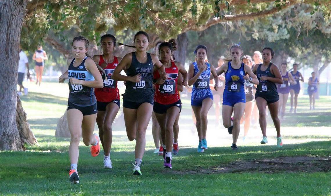 Clovis North senior Ashlyn Leath leads the pack during the Dennis DeWitt Invitational at Lions Town & Country Park in Madera on Aug. 27, 2022. She won with a time of 11:00.3 on the 3,000-meter course.