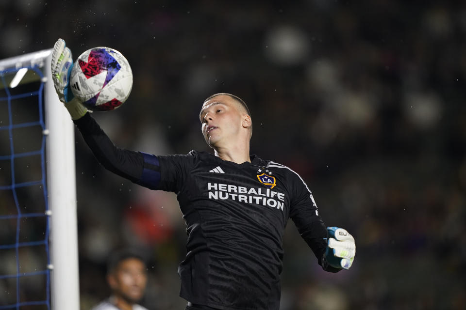 LA Galaxy goalkeeper Novak Micovic jumps to grab the ball during the first half of the team's MLS soccer match against Real Salt Lake on Saturday, Oct. 14, 2023, in Carson, Calif. (AP Photo/Ryan Sun)