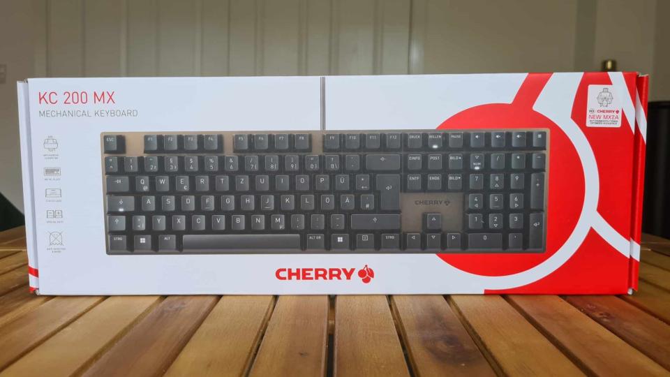 Cherry KC 200 MX gaming keyboard on a wooden table.