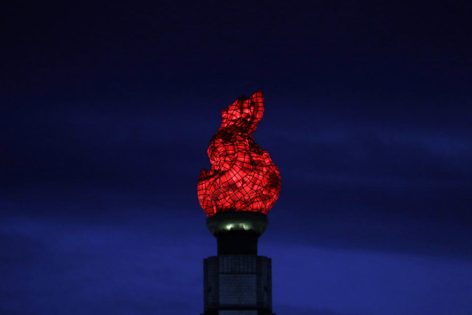 In this Sept. 15, 2018, photo, the Tower of Juche Idea is lit up in Pyongyang, North Korea. The word Juche is splashed across countless propaganda signs in North Korea and featured in hundreds of state media reports, and while it’s technically a political ideology, it can seem more like a religion because of its difficulty for many outsiders to grasp and ability to inspire devotion among North Koreans. (AP Photo/Kin Cheung)