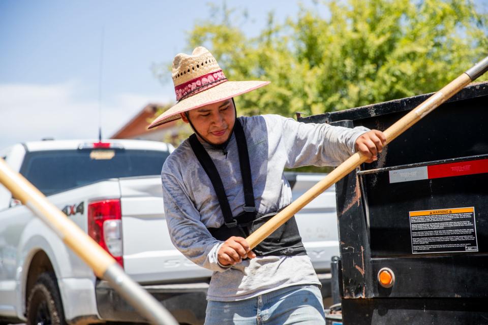 Cleverson Gomez sweats through his shirt as he shovels dirt in Surprise, Arizona on July 26, 2023, when temperatures for the day hit 116 degrees. Arizona is among the states that experience extreme heat but do not have statewide heat protections for its outdoor workers.