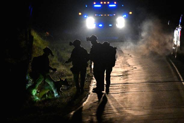 Law enforcement are seen outside the home of suspect Robert Card’s father and brother in Bowdoin, Maine on 26 October 2023 (AFP via Getty Images)