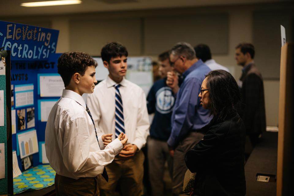 (left to right) Jackson Boudreaux and William Bolding present their project to a judge during Bartlesville District Science Fair held at the Phillips 66 Research Center.