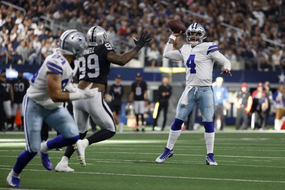 Dallas Cowboys tight end Sean McKeon (84) runs a route as Las Vegas Raiders defensive end Clelin Ferrell (99) rushes against Cowboys quarterback Dak Prescott (4) in the first half of an NFL football game in Arlington, Texas, Thursday, Nov, 25, 2021. Prescott completed the pass to McKeon for a touchdown. (AP Photo/Ron Jenkins)