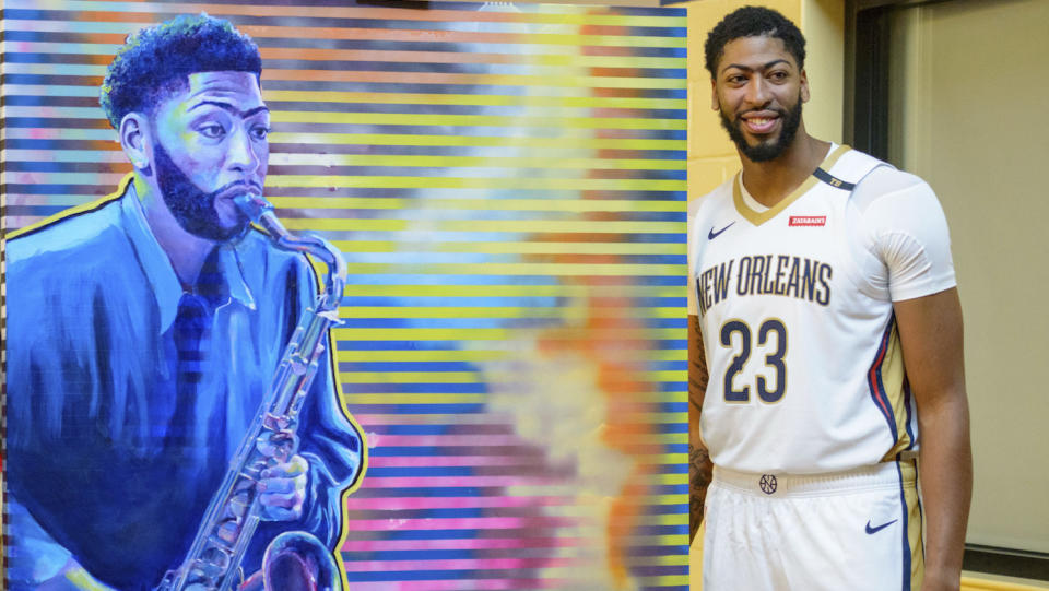 Anthony Davis poses next to a painting of himself playing a saxophone on media day, of course. (AP)