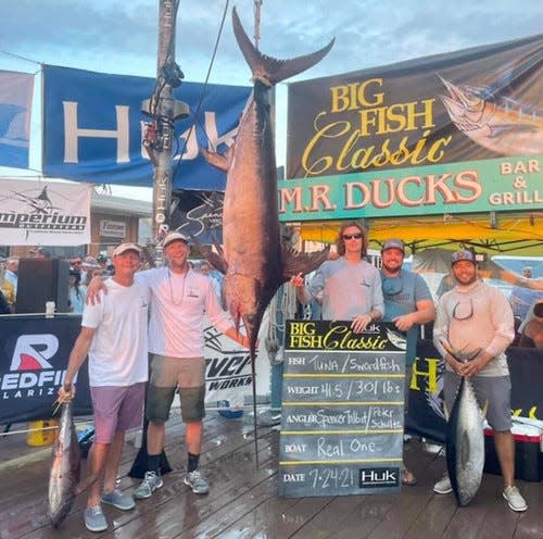 Peter Schultz, second from left, and his team post with their record-setting 301-pouond swordfish caught at the Big Fish Classic Tournament on July 23.