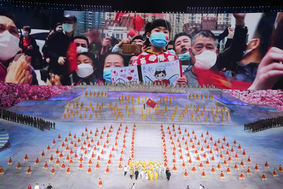 Performers take part in a gala show ahead of the 100th anniversary of the founding of the Chinese Communist Party in Beijing on Monday, June 28, 2021. A spectacular outdoor gala attended by Chinese President Xi Jinping in Beijing on Monday night relived what is known as the Long March of the 1930s, featured men singing with giant wrenches and women with bushels of wheat, and had special forces climbing a mountain and medical workers battling COVID-19 in protective gear. (AP Photo/Ng Han Guan)