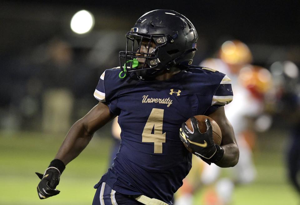 University Christian's Orel Gray (4) looks over his shoulder as he sprints to the end zone for a fourth quarter touchdown on Friday, December 2, 2022.