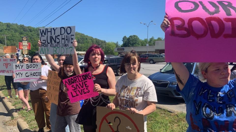 More than two dozen Madison County students, teachers and community members gathered May 11 for a women's rights rally organized by Madison Early College High School freshman, Rose Jeffrey.