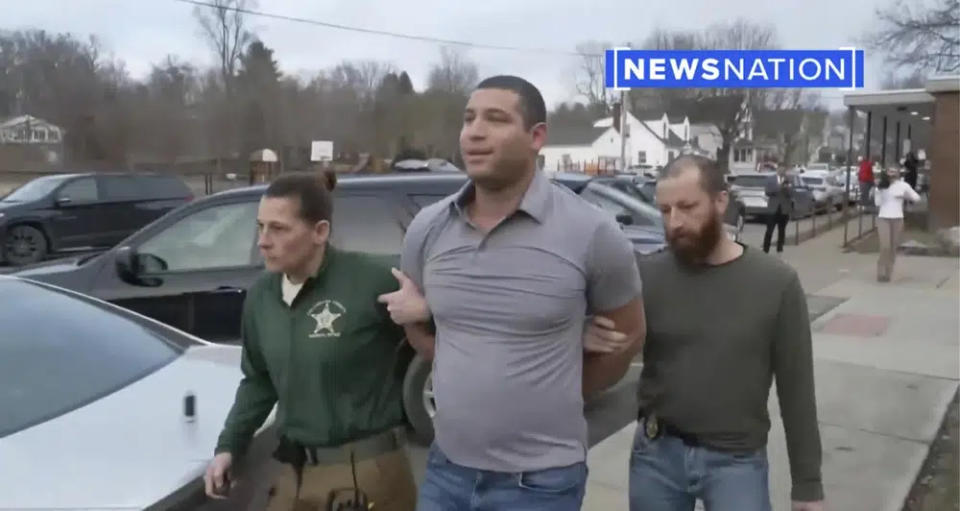 This image taken from video provided by Newsnation/TMX shows reporter Evan Lambert being taken into police custody on Wednesday, Feb. 8, 2023 in East Palestine, Ohio. (Newsnation TMX via AP)