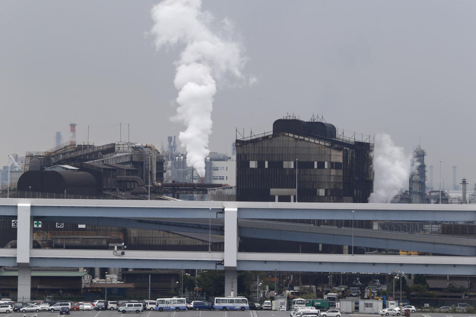 FILE - In this Oct. 21, 2013, file photo, smoke billows from an oil refinery in Kawasaki, southwest of Tokyo. Japan on Friday, Oct. 22, 2021, adopted a new energy policy that pushes for nuclear and renewables as sources of clean energy to achieve the country’s pledge of reaching carbon neutrality in 2050.(AP Photo/Koji Sasahara, File)