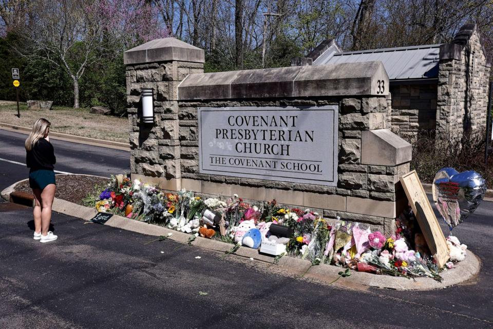 PHOTO: A woman pauses as she visits a memorial at the entrance to The Covenant School, March 29, 2023, in Nashville, Tenn. (Wade Payne/AP, FILE)