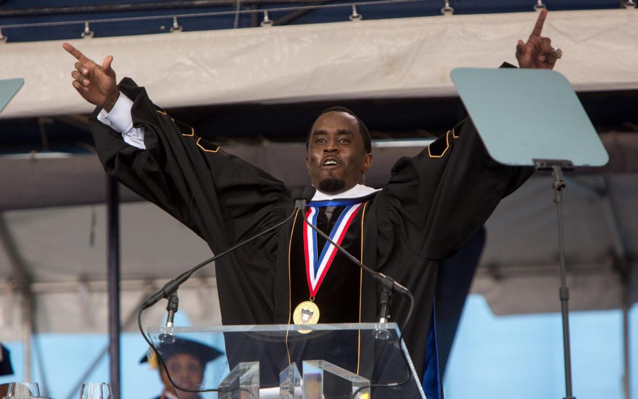 Sean 'Diddy' Combs beaming in a black gown and mortar board as he was awarded an honorary degree by Howard University