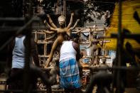 An artisan makes an idol of Hindu goddess Durga in a workshop ahead of the 'Durga Puja' festival in New Delhi on October 14, 2020. (Photo by Jewel SAMAD / AFP) (Photo by JEWEL SAMAD/AFP via Getty Images)