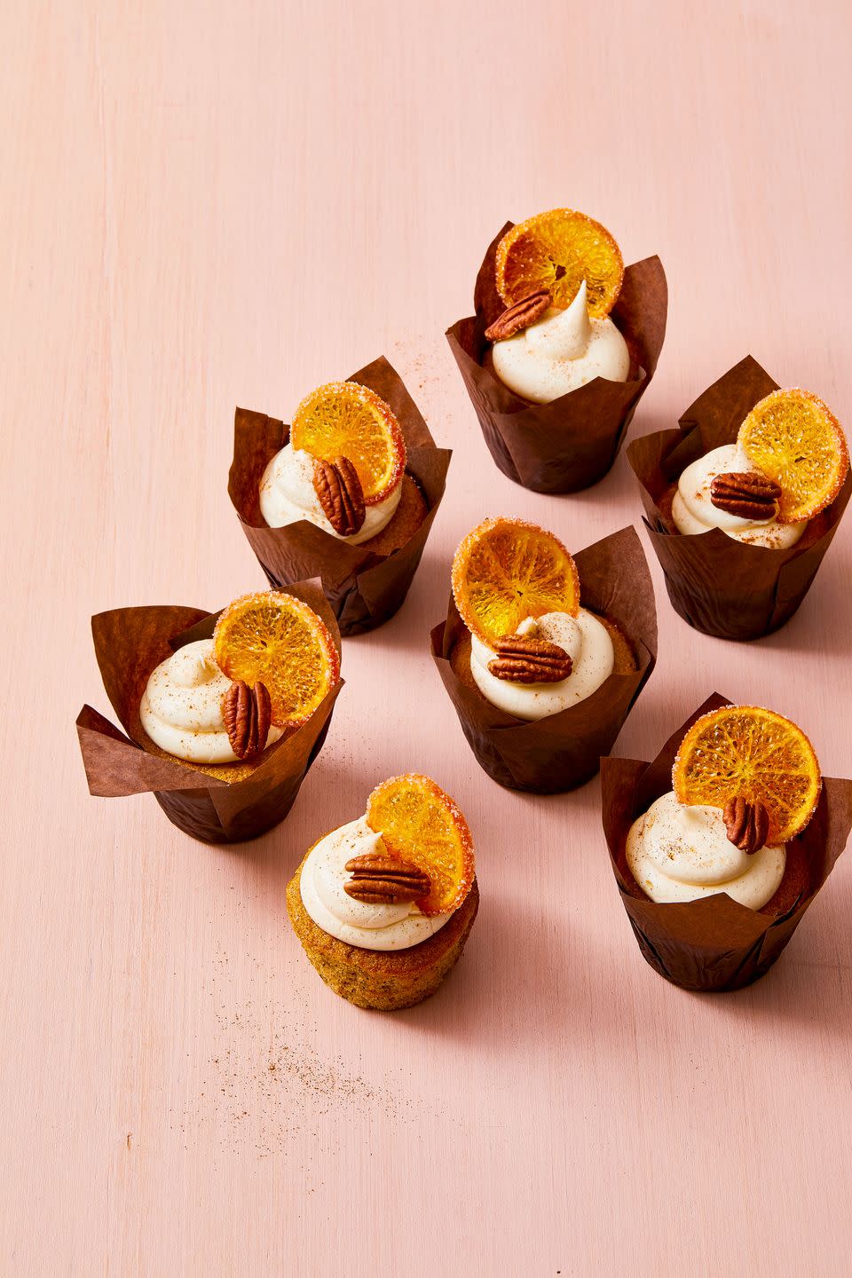 <p>These spiced bites get extra holiday flair from store-bought <a href="https://www.amazon.com/Trader-Joes-Sweetened-Orange-Slices/dp/B01KN755VI/?linkCode=ogi&tag=syn-yahoo-20&ascsubtag=%5Bartid%7C10055.g.40601886%5Bsrc%7Cyahoo-us" rel="nofollow noopener" target="_blank" data-ylk="slk:candied orange slices" class="link ">candied orange slices</a>.</p><p>Get the <a href="https://www.goodhousekeeping.com/food-recipes/a36972545/pecan-cupcakes-with-spiced-vanilla-frosting-recipe/" rel="nofollow noopener" target="_blank" data-ylk="slk:Pecan Cupcakes With Spiced Vanilla Frosting recipe" class="link "><strong>Pecan Cupcakes With Spiced Vanilla Frosting recipe</strong></a>.</p>