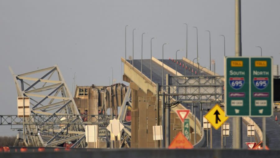 Parts of the Francis Scott Key Bridge remain after a container ship collided with a support Tuesday, March 26, 2024 in Baltimore. The major bridge in Baltimore snapped and collapsed after a container ship rammed into it early Tuesday, and several vehicles fell into the river below. Rescuers were searching for multiple people in the water. (AP Photo/Steve Ruark)