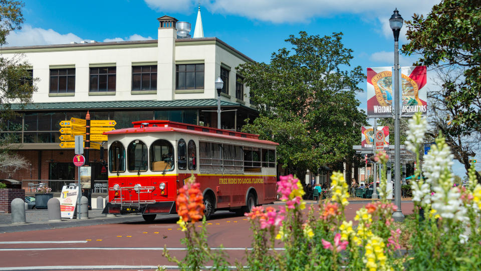 People on a street car on a sunny day in the picturesque downtown of Tallahassee, the capital city of the southern US state of Florida.