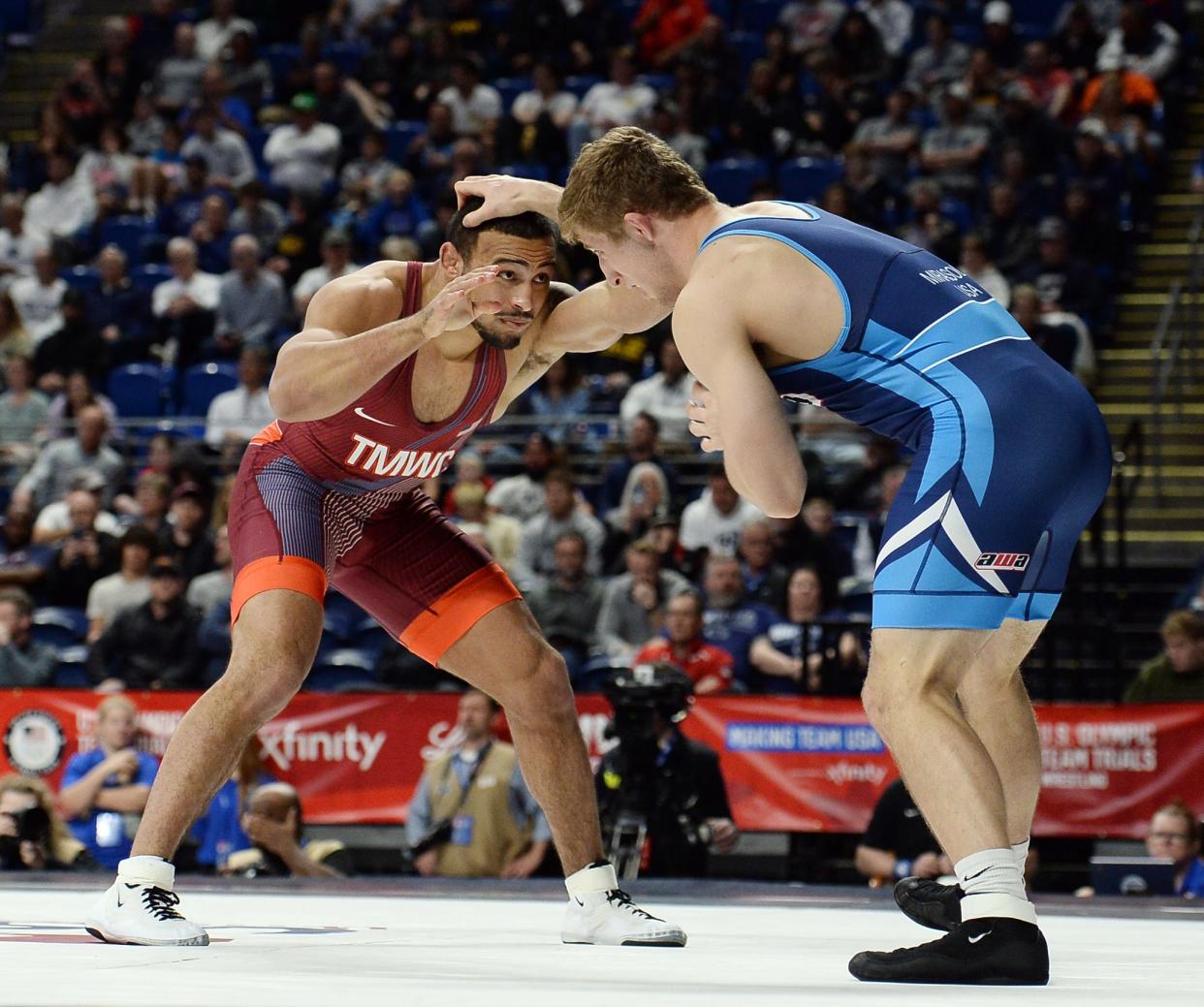 Aaron Brooks, left, faces Connor Mirasola in his first match at the U.S. Olympic Wrestling Trials at Penn State's Bryce Jordan Center on Friday, April 19, 2024.