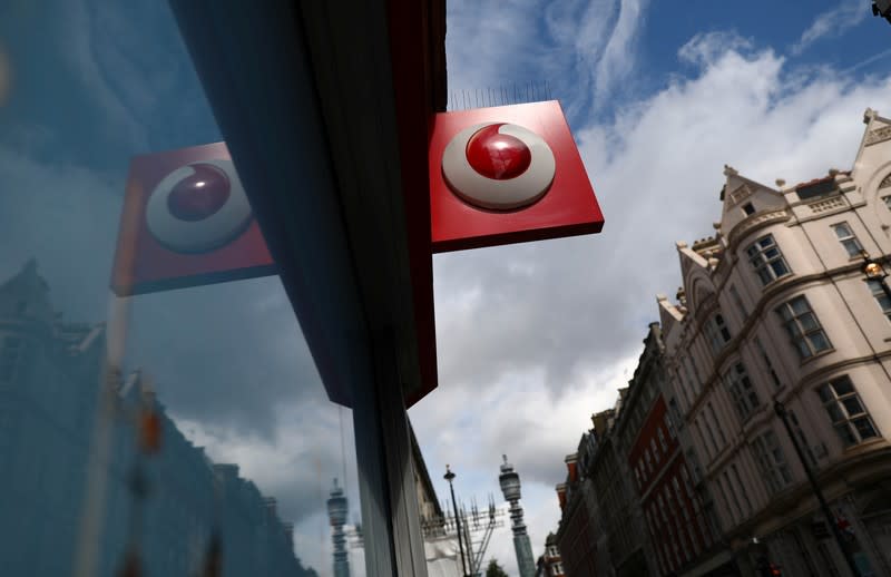 A branded sign is displayed on a Vodafone store in London