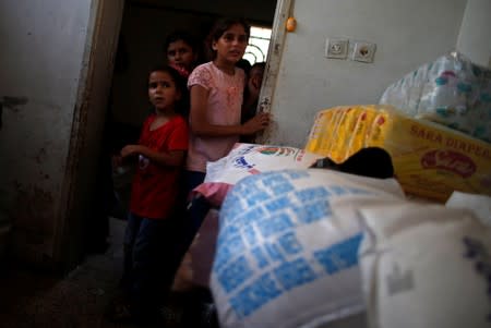 Palestinian children attend the funeral of Hamas fighter Mahmoud Al-Adham, 28, in the northern Gaza Strip