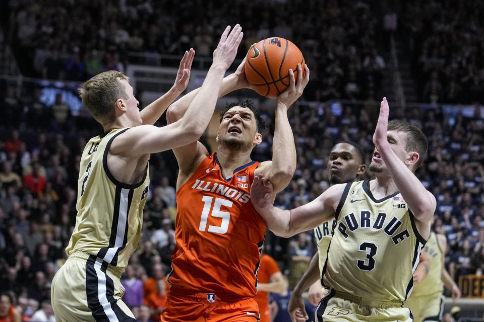 Illinois guard RJ Melendez (15) shoots between Purdue guard Fletcher Loyer (2) and guard Braden Smith (3) during the first half of an NCAA college basketball game in West Lafayette, Ind., Sunday, March 5, 2023. (AP Photo/Michael Conroy)
