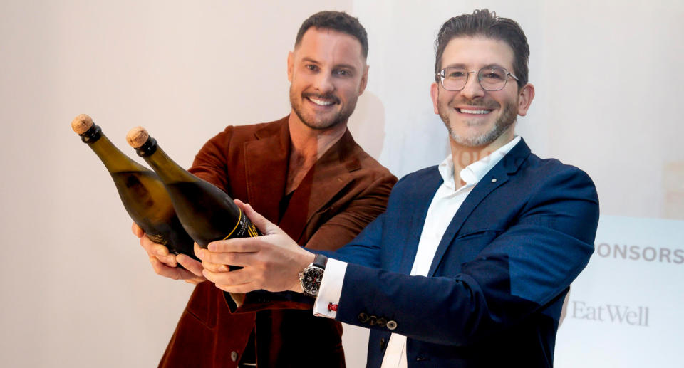 Darren Palmer and Rick Bazerghi celebrate the success of Meir by popping champagne.