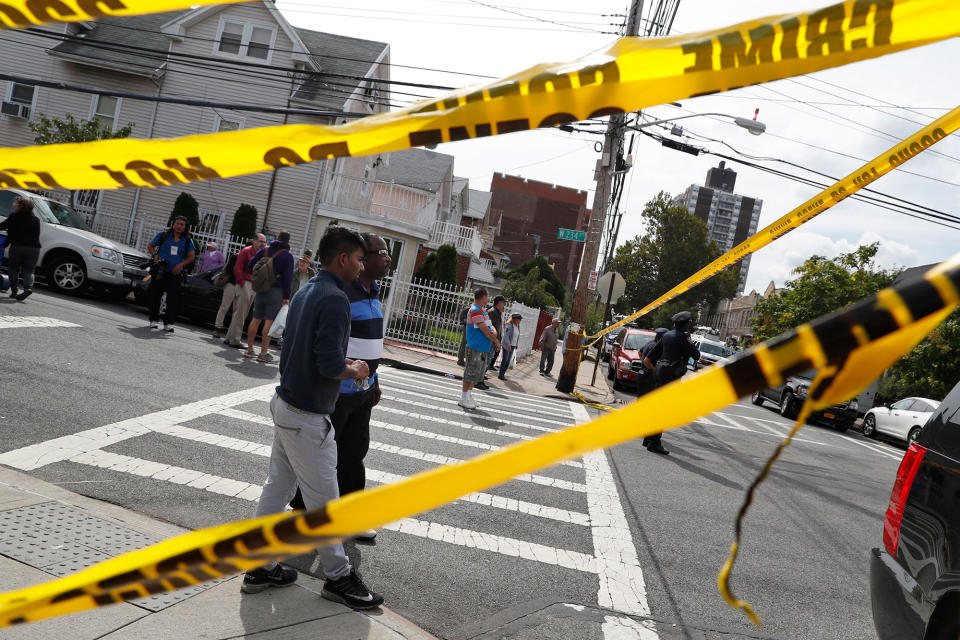 <p>Neighborhood residents watch as emergency service personnel work at the scene of a house explosion, Tuesday, Sept. 27, 2016, in the Bronx borough of New York. (AP Photo/Mary Altaffer) </p>