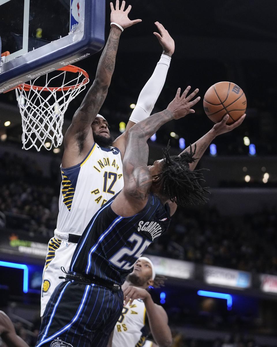 Orlando Magic's Admiral Schofield (25) shoots against Indiana Pacers' Oshae Brissett (12) during the first half of an NBA basketball game, Monday, Nov. 21, 2022, in Indianapolis. AP Photo/Darron Cummings)