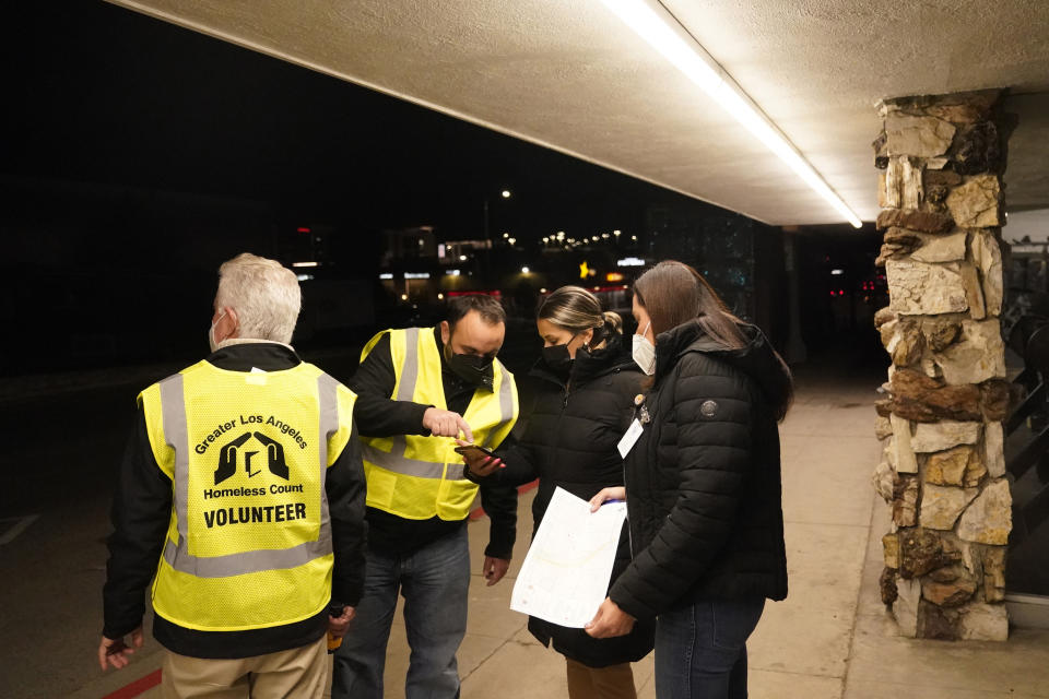 Los Angeles city councilmember Paul Krekorian, left, participates in the homeless count with members of his staff Karo Torossian, second from left, Diana Gonzales, center, and Lorraine Diaz Tuesday, Feb. 22, 2022, in the North Hollywood section of Los Angeles. Los Angeles County has resumed its annual homeless count in full a year after it was limited over concerns that it couldn't be done safely or accurately during the coronavirus pandemic. (AP Photo/Marcio Jose Sanchez)