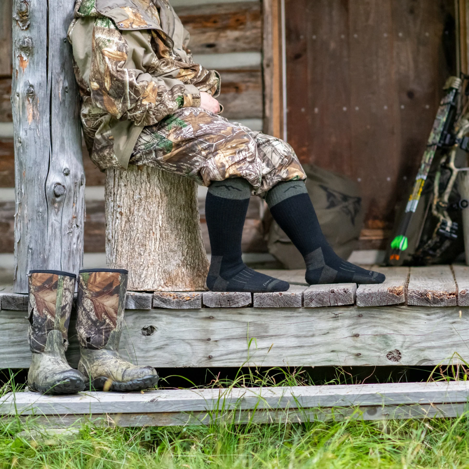 A hunter sits in socks