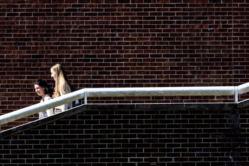 University of Delaware students exit Kirkbride Hall on a sunny and warm winter day in Newark, Thursday, Feb. 23, 2023.