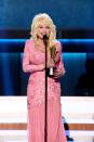 <p>A hue Parton returns to again and again, she always manages to look extra-special in this bubblegum pink. Accepting the Gary Haber Lifting Lives Award from the Academy of Country Music, Dolly exudes Southern charm and beauty in this floral, beaded gown.</p>