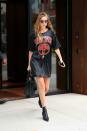 <p>In a t-shirt dress by Moschino, oversized red sunglasses, Saint Laurent crocodile tote bag and zip-up sock boots while out in New York.</p>