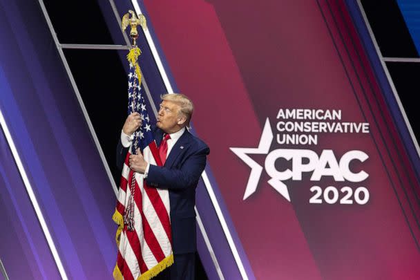 PHOTO: President Donald Trump hugs and kisses the American flag during the Conservative Political Action Conference (CPAC) in National Harbor, Md., Feb. 29, 2020.  (Bloomberg via Getty Images)