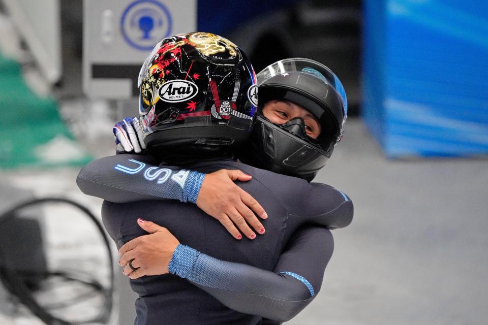 Elana Meyers Taylor and Sylvia Hoffman (USA) hug after their run in the two-man bobsled. They won bronze.