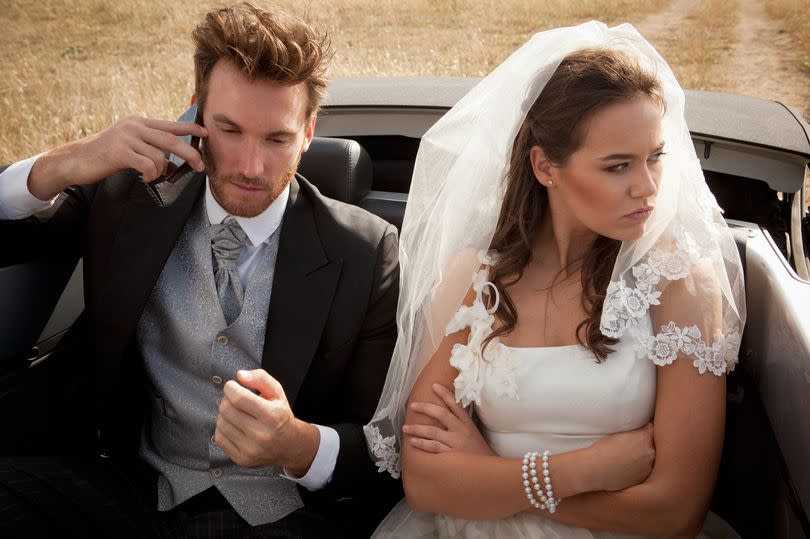 Newlywed couple arguing in car