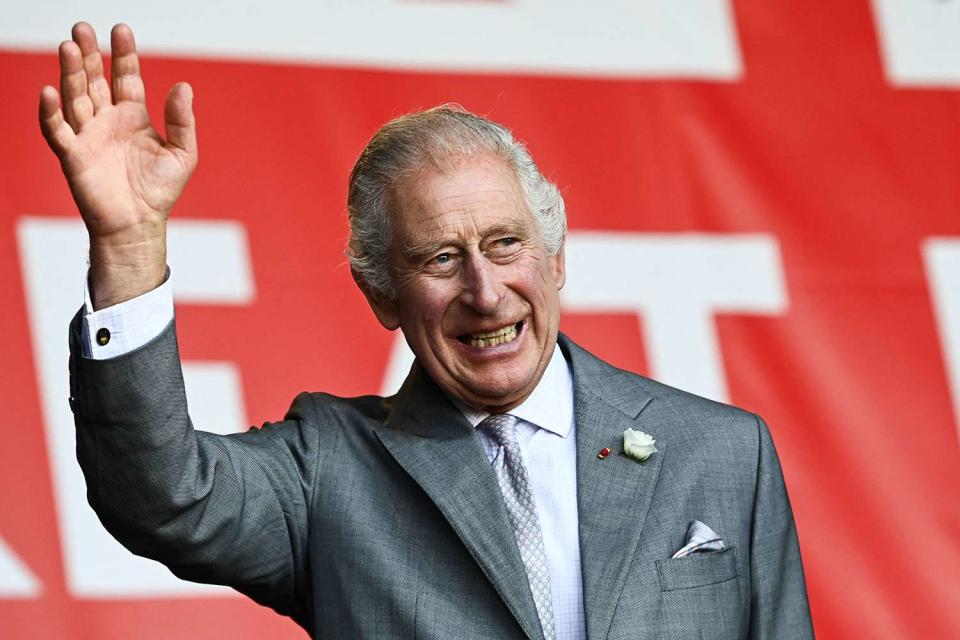 <p>CHRISTOPHE ARCHAMBAULT/POOL/AFP via Getty Images</p> King Charles waves during a stop in Bordeaux during a state visit to France in September 2023