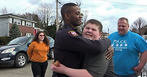 Officer Khari Manzini poses with Ryan Paul after responding to an emergency call for a “teddy bear rescue.” (Credit: Bob Paul)