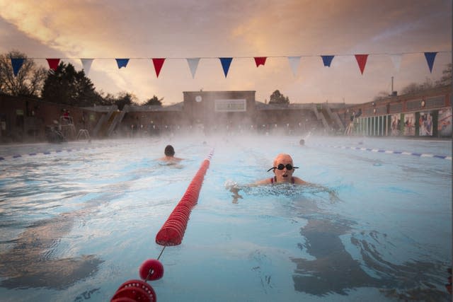 Early morning swimmers during sunrise at Charlton Lido in Hornfair 