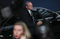 Irish Foreign Minister Simon Coveney, top, arrives as European Union Foreign Policy chief Federica Mogherini talks to journalists during an European Foreign Affairs Ministers meeting at the Europa building in Brussels, Monday, Nov. 11, 2019. European Union foreign ministers are discussing ways to keep the Iran nuclear deal intact after the Islamic Republic began enrichment work at its Fordo power plant. (AP Photo/Francisco Seco)